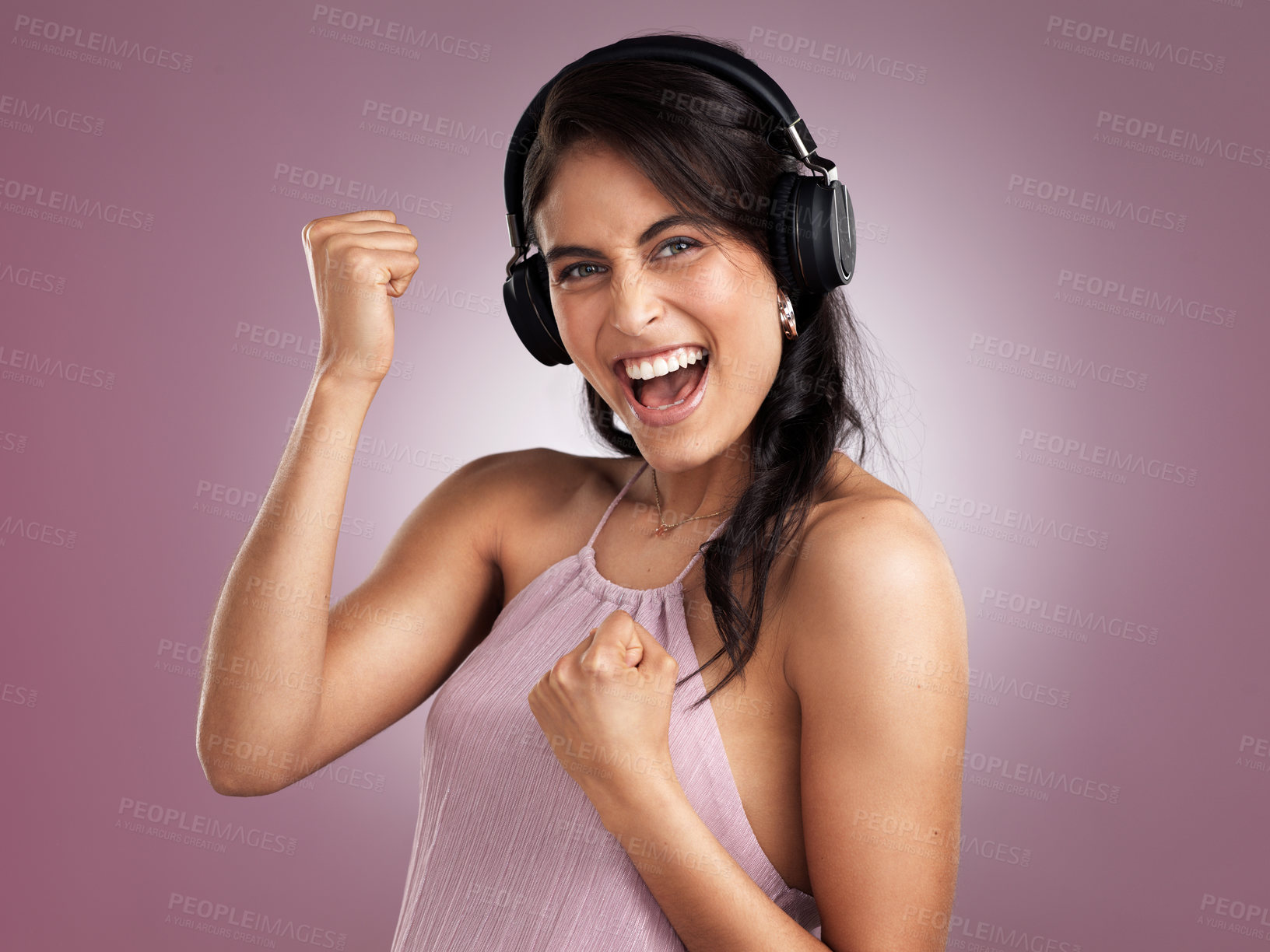 Buy stock photo Shot of a beautiful young cheerful woman celebrating while wearing headphones against a pink background