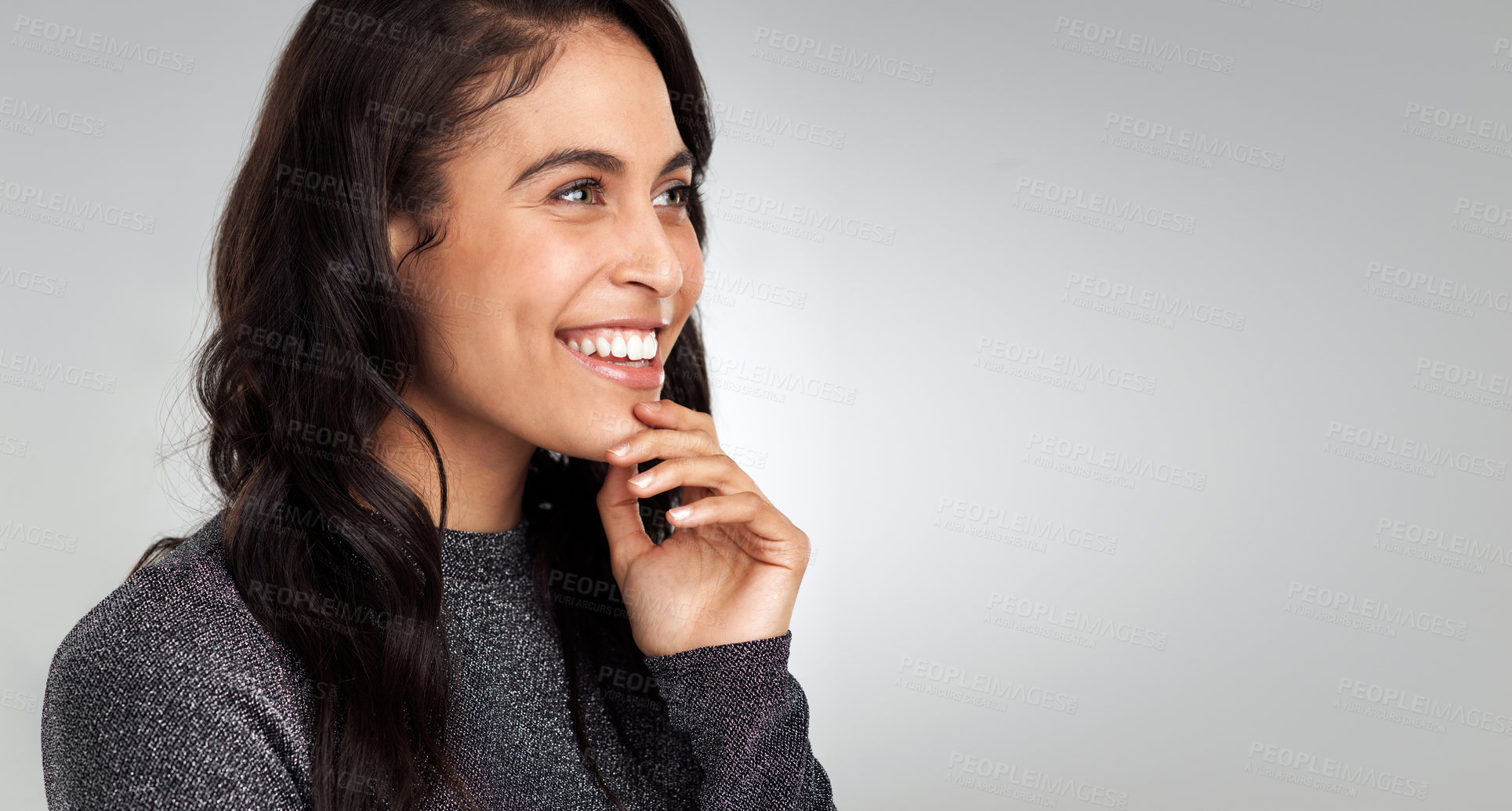 Buy stock photo Shot of a beautiful young woman looking thoughtful while standing against a white background