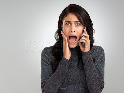 Buy stock photo Shot of a woman looking shocked while talking on her cellphone