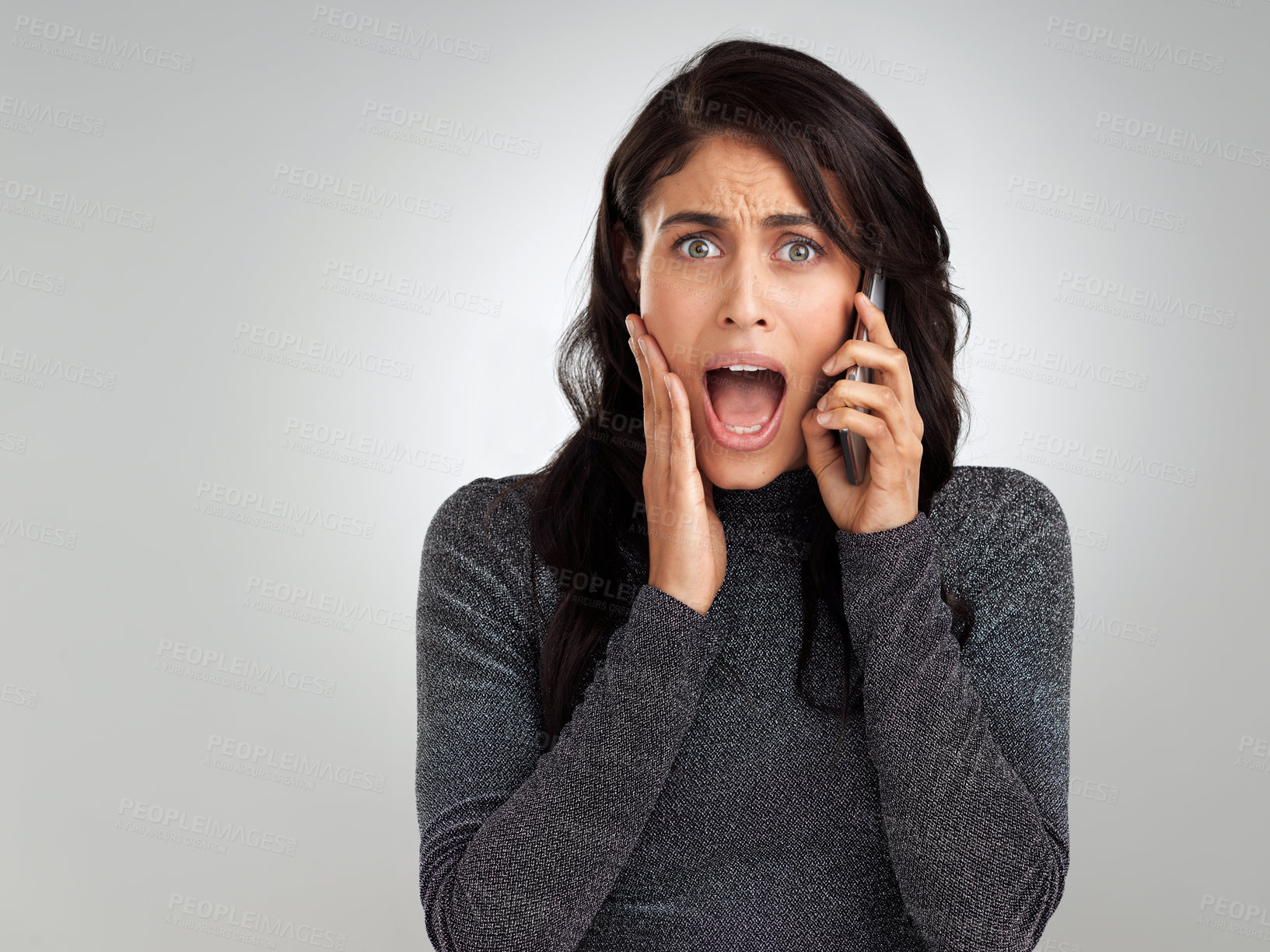 Buy stock photo Shot of a woman looking shocked while talking on her cellphone