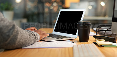 Buy stock photo Cropped shot of an unrecognizable businessman sitting alone and working on his laptop in his office late at night