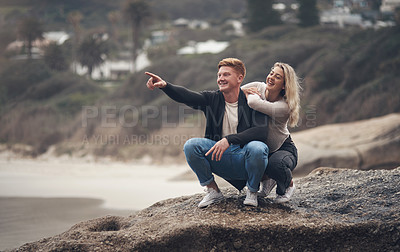 Buy stock photo Shot of a young couple spending the day together at the beach