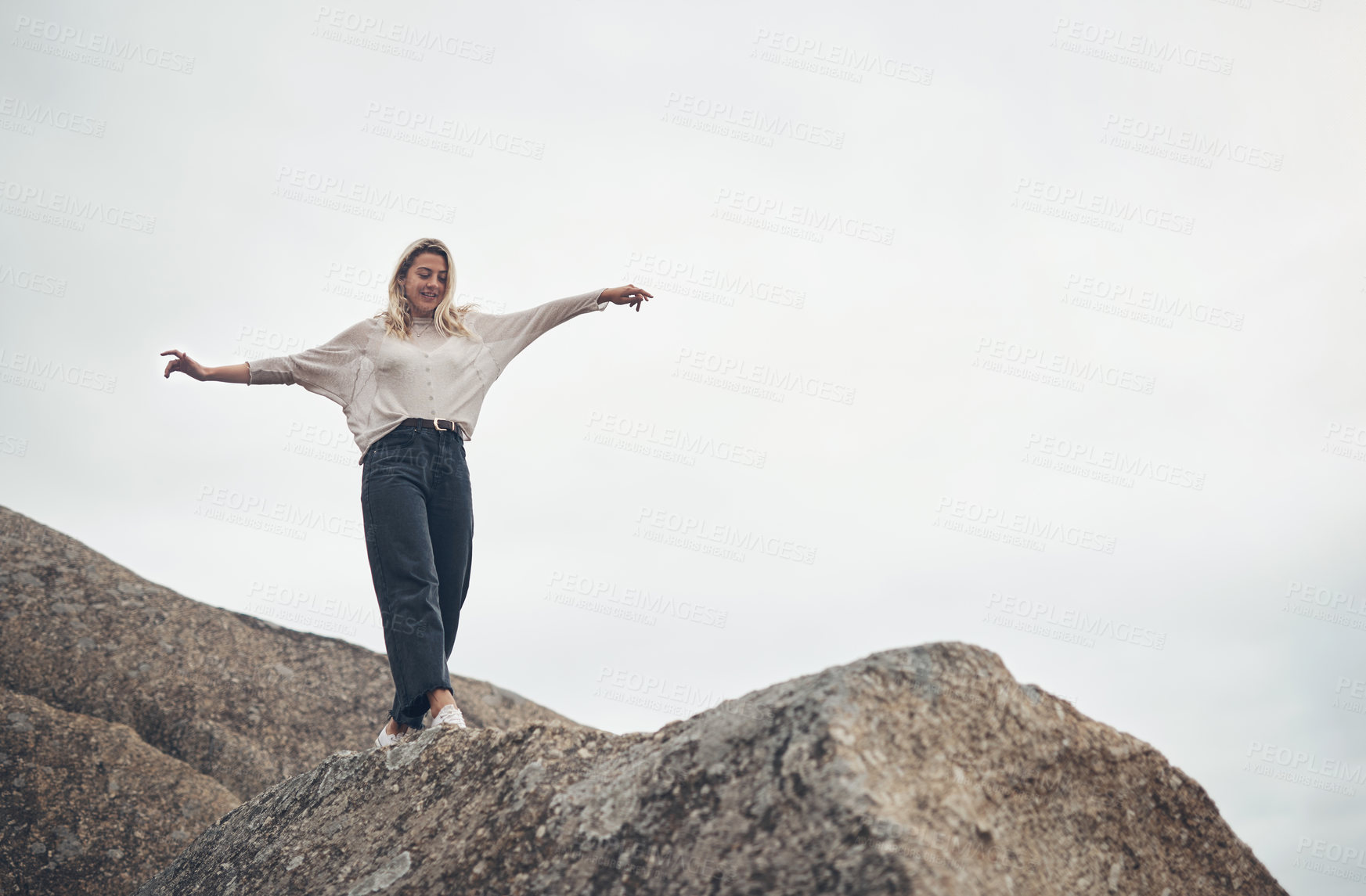 Buy stock photo Shot of a beautiful young woman spending the day at the beach