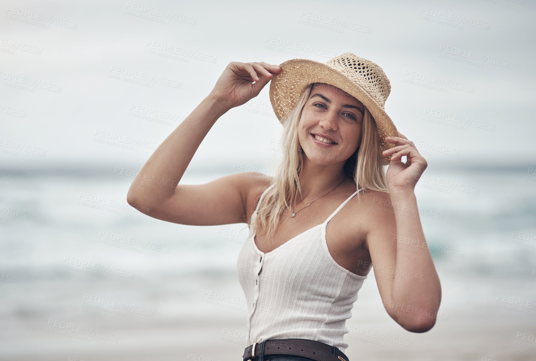 Buy stock photo Shot of a beautiful young woman spending the day at the beach