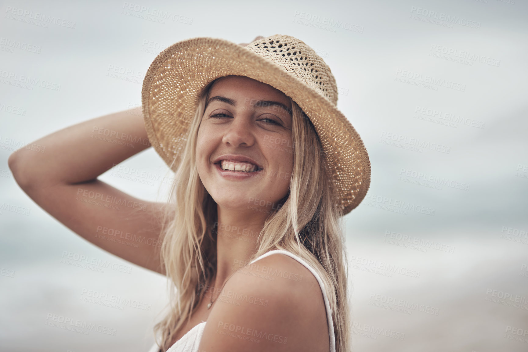 Buy stock photo Shot of a beautiful young woman spending the day at the beach