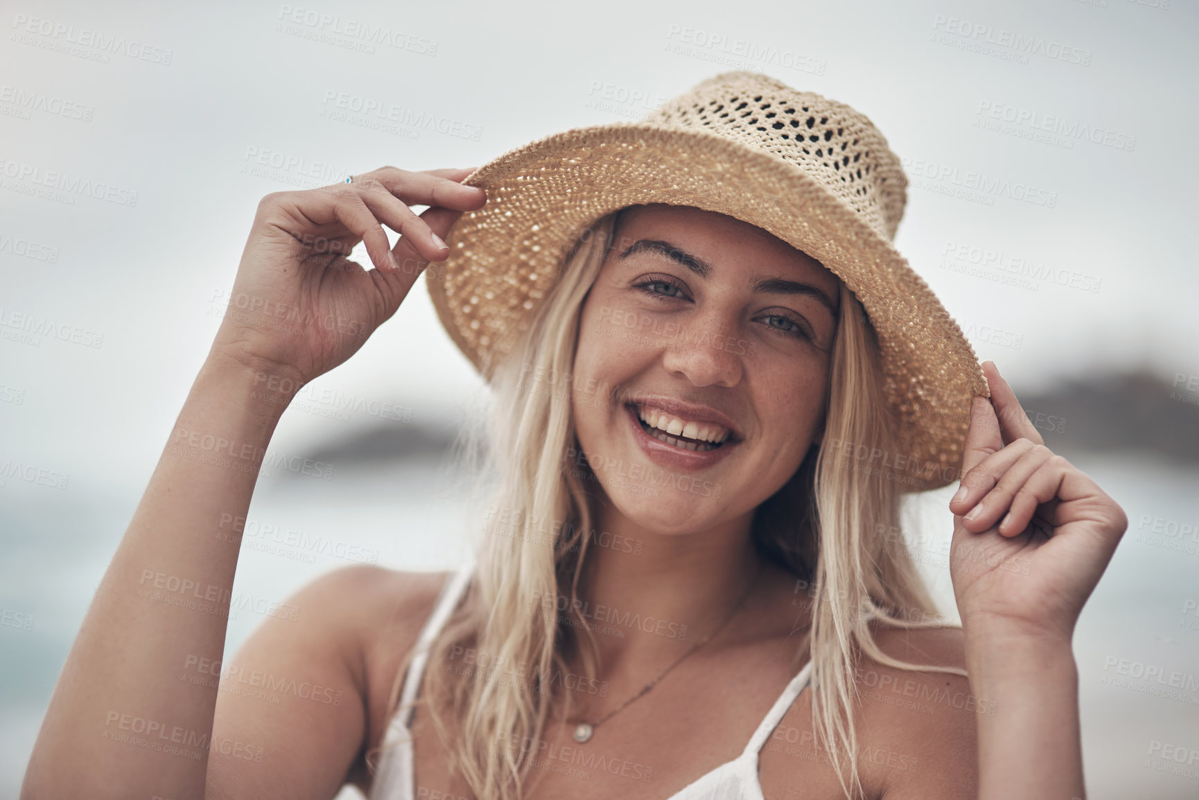 Buy stock photo Shot of a beautiful young woman spending the day at the beach