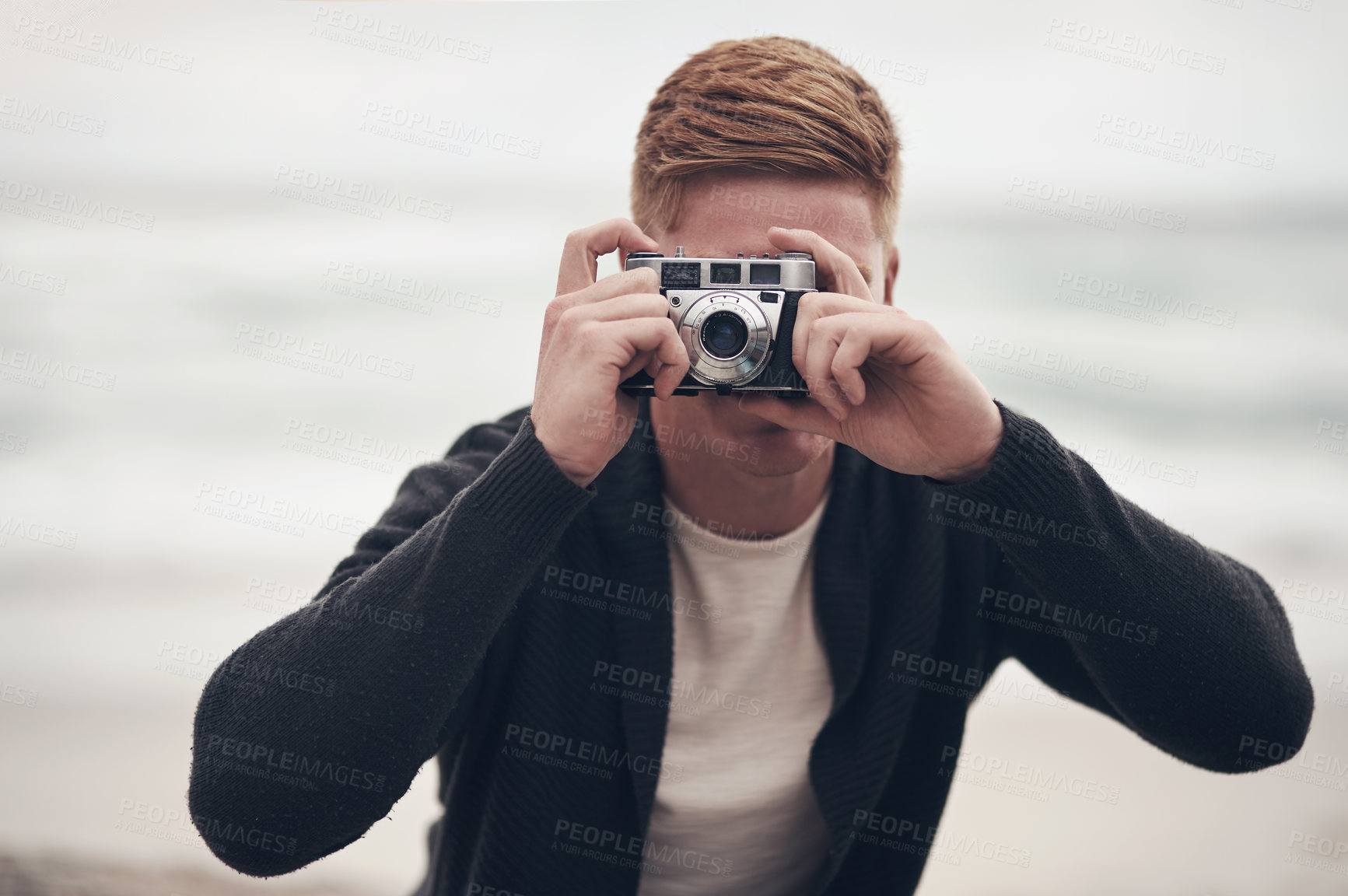 Buy stock photo Camera, photography and travel with man on beach for holiday, tourism or vacation in morning. Capture, memories and photograph with tourist person outdoor in nature for adventure, break or getaway