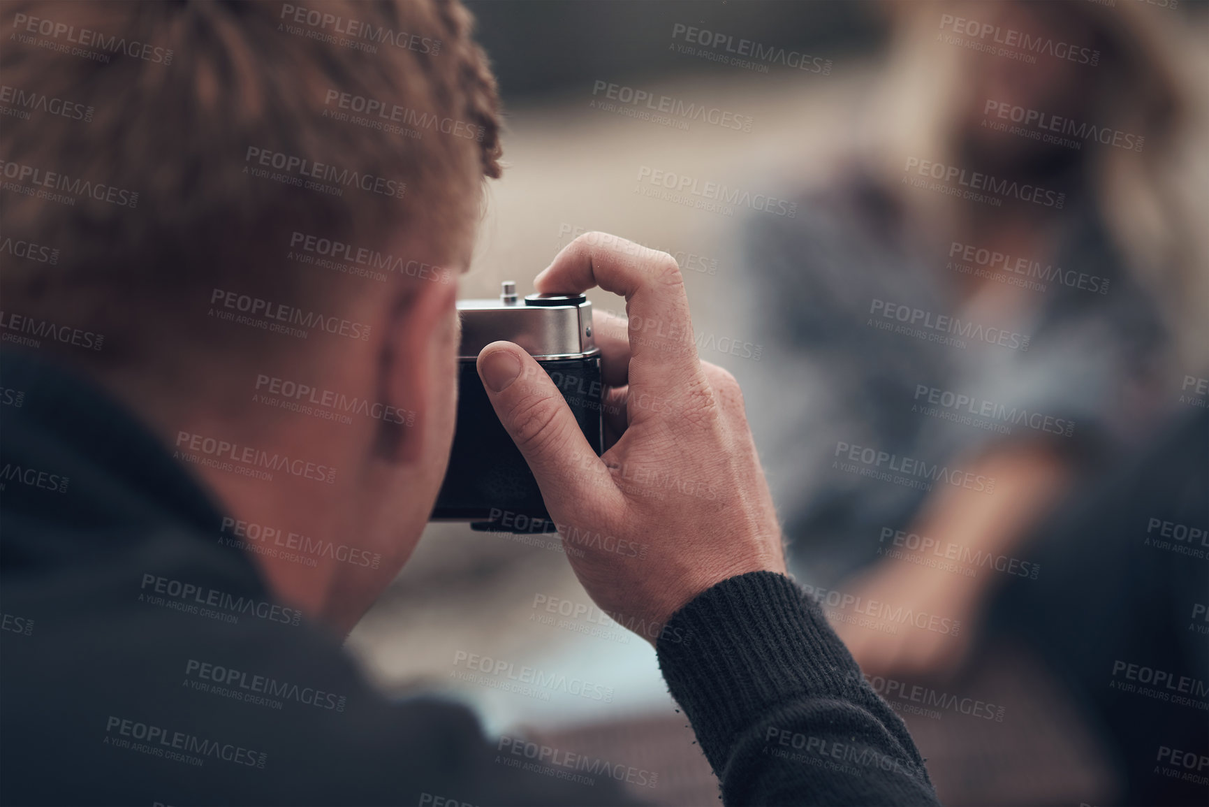 Buy stock photo Shot of a man taking pictures with his camera on the beach