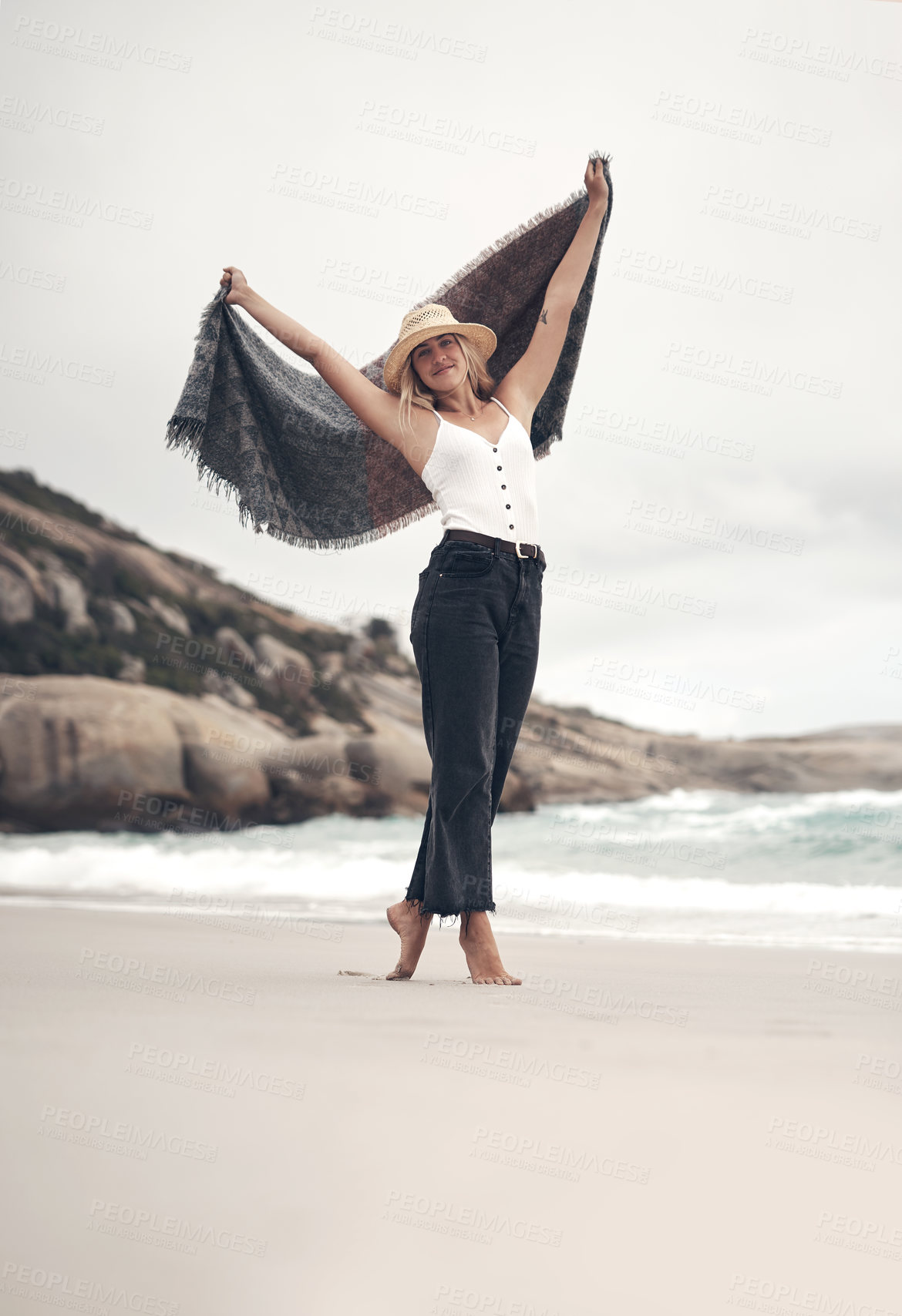 Buy stock photo Shot of a beautiful young woman spending the day at the beach