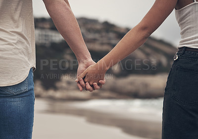 Buy stock photo Cropped shot of an unrecognisable couple holding hands on the beach