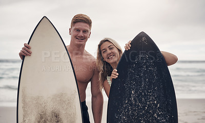 Buy stock photo Shot of a couple out at the beach with their surfboards