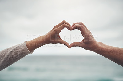 Buy stock photo Cropped shot of a couple forming a heart shape with their hands