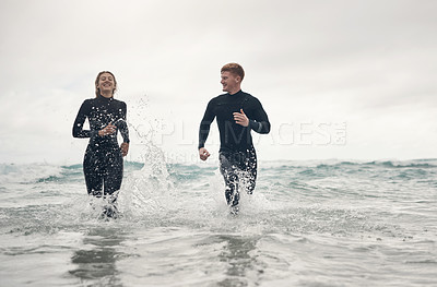 Buy stock photo Shot of a young couple spending the day at the beach