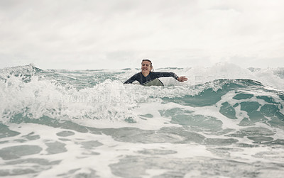 Buy stock photo Shot of a young woman out surfing at the beach