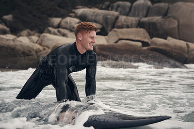 Buy stock photo Shot of a young man out surfing at the beach