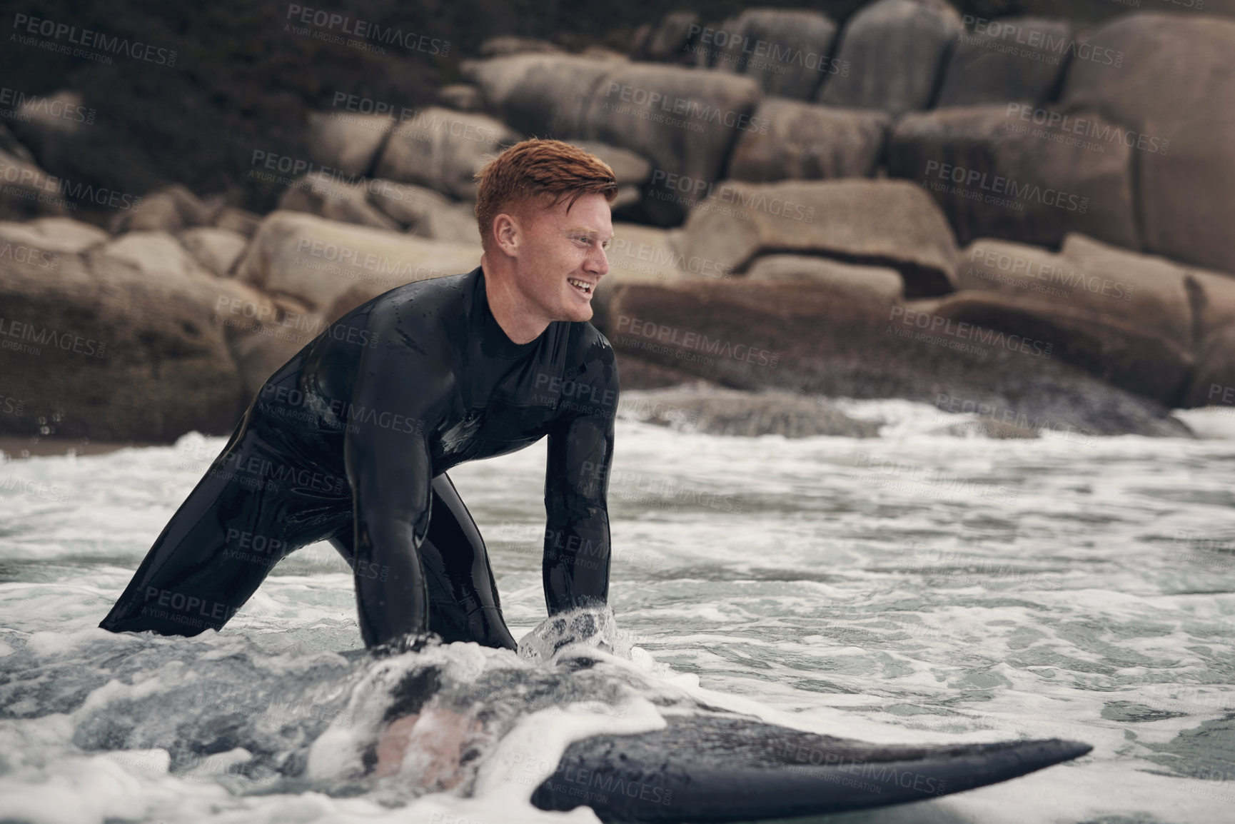 Buy stock photo Shot of a young man out surfing at the beach