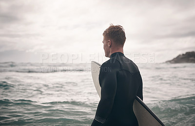 Buy stock photo Shot of a young man out surfing at the beach