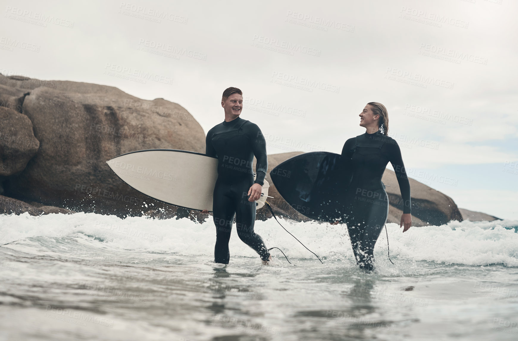 Buy stock photo Shot of a young couple out surfing together at the beach