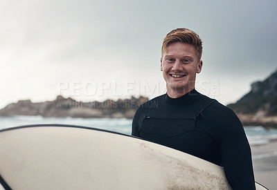 Buy stock photo Cropped shot of a man holding his surfboard while at the beach