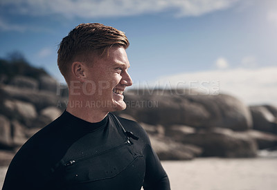 Buy stock photo Cropped shot of a young man wearing a wetsuit while at the beach