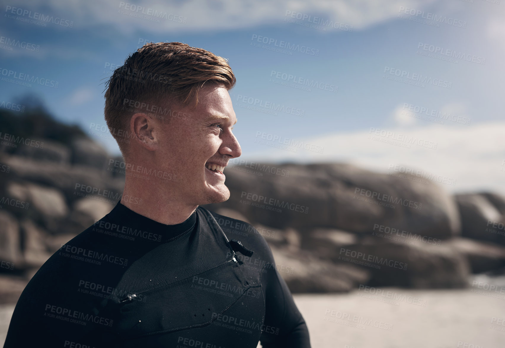 Buy stock photo Cropped shot of a young man wearing a wetsuit while at the beach