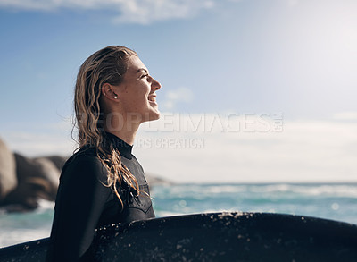 Buy stock photo Cropped shot of a young woman holding her surfboard while at the beach
