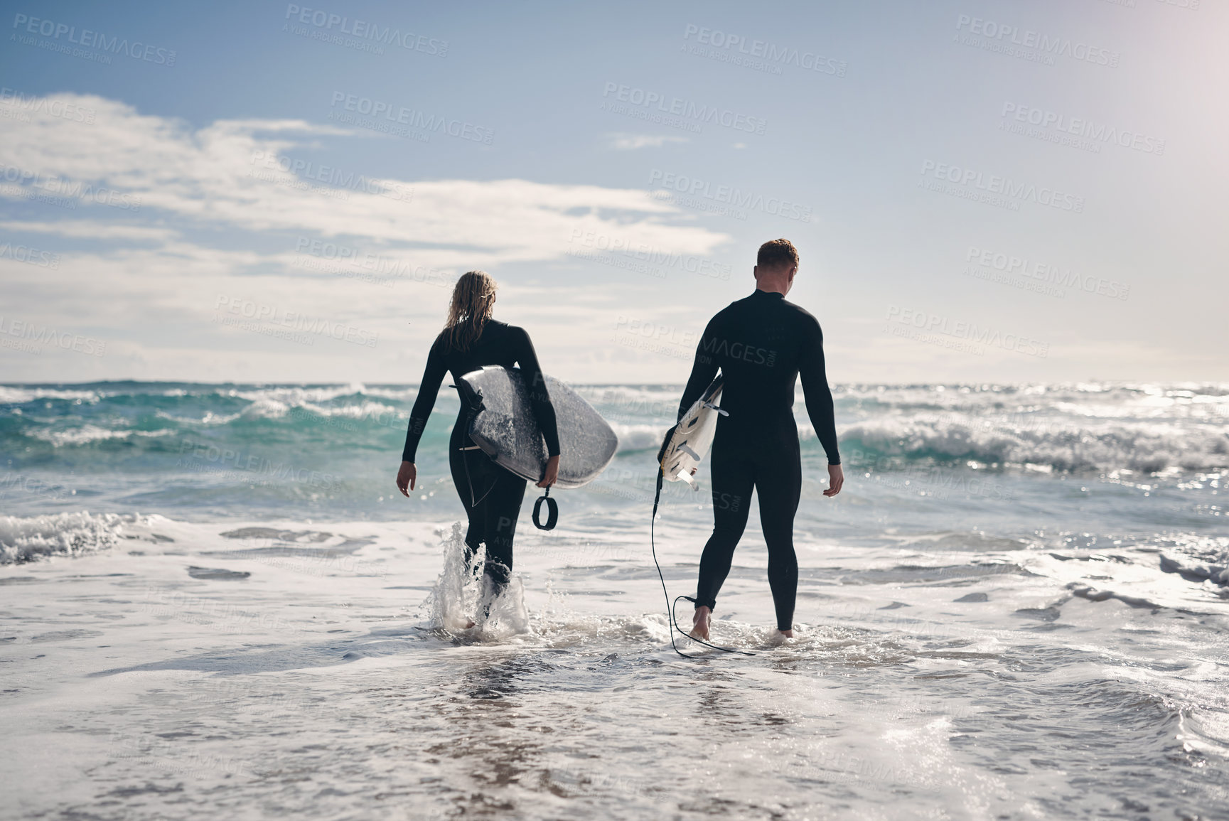 Buy stock photo Shot of a young couple out surfing together at the beach