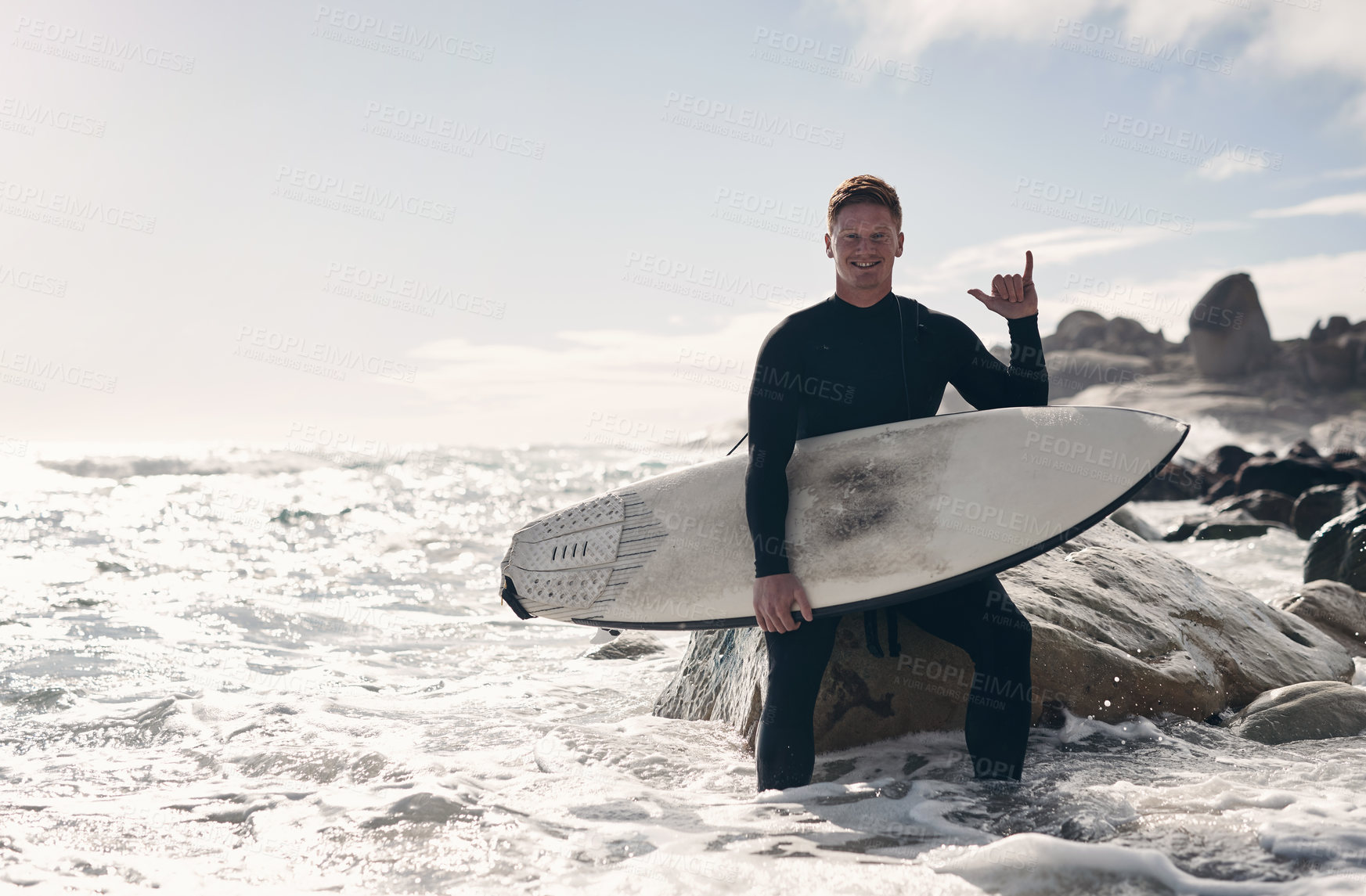 Buy stock photo Shot of a young man out surfing at the beach