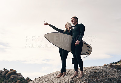 Buy stock photo Shot of a young couple out surfing together at the beach