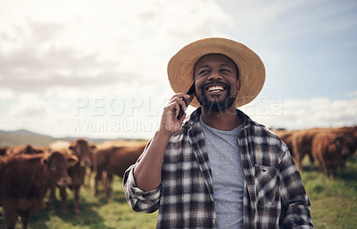 Buy stock photo Shot of a mature man using a smartphone while working on a cow farm