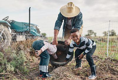 Buy stock photo Shot of a mature man working his adorable son and daughter on a farm
