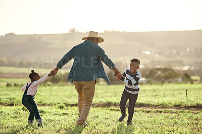 Buy stock photo Shot of an adorable brother and sister having fun with their father on a farm