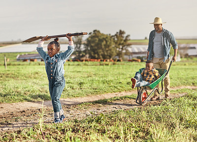 Buy stock photo Shot of a mature man working his adorable son and daughter on a farm