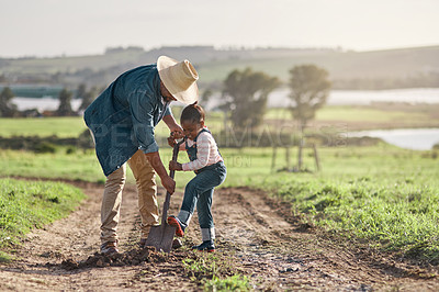 Buy stock photo Shot of a mature man working his adorable daughter on a farm