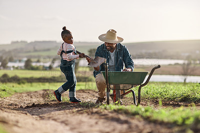 Buy stock photo Shot of a mature man working his adorable daughter on a farm