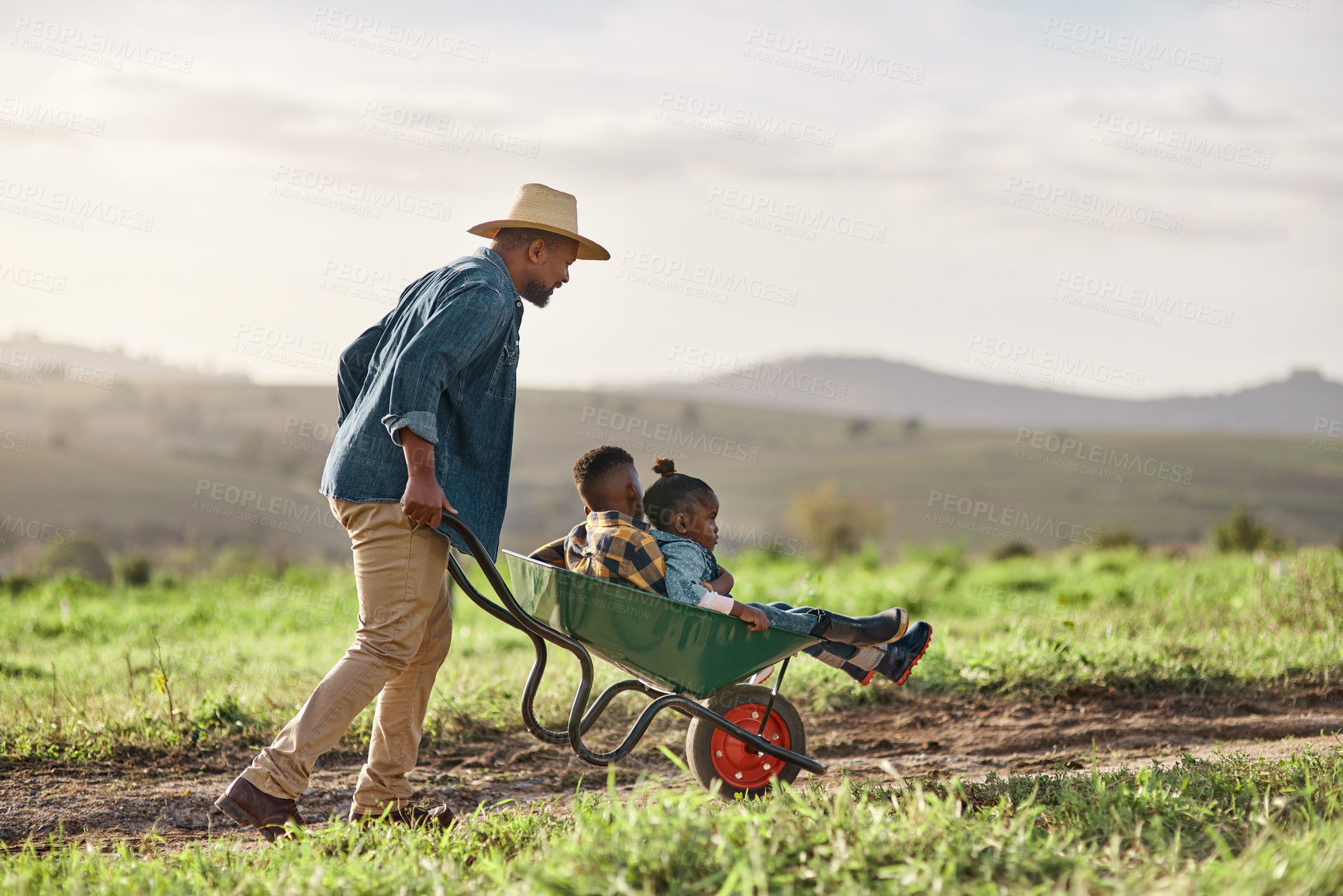 Buy stock photo Shot of a mature man working his adorable son and daughter on a farm