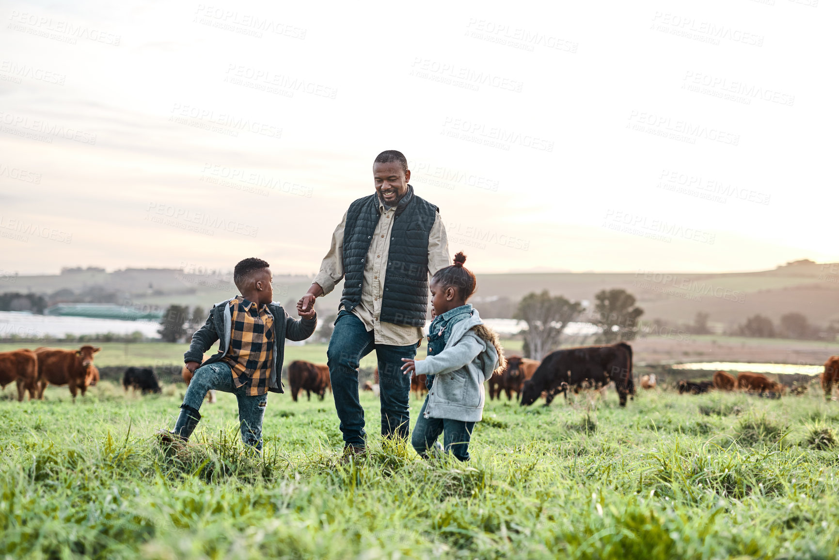 Buy stock photo Shot of an adorable brother and sister having fun with their father on a farm