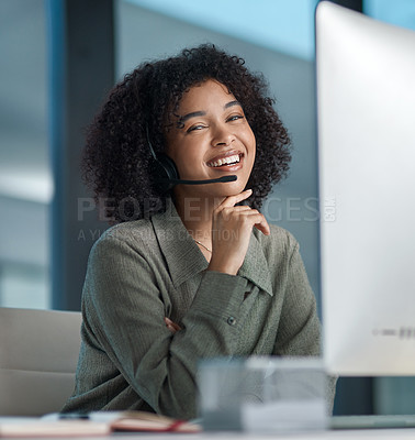 Buy stock photo Shot of a young female agent smiling away from her monitor with her hand on her chin while working in a call centre