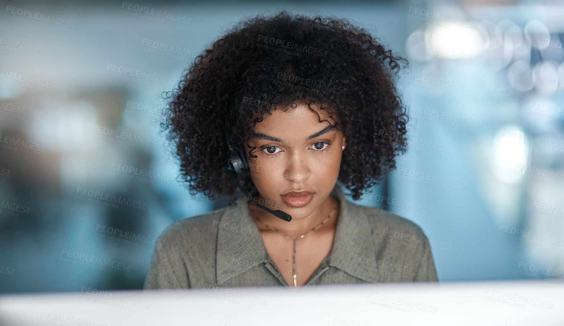 Buy stock photo Cropped shot of a young female agent listening intently to a callers problem while working in a call centre