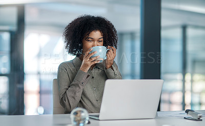 Buy stock photo Shot of a young female agent working in a call centre taking a moment to enjoy a sip of coffe