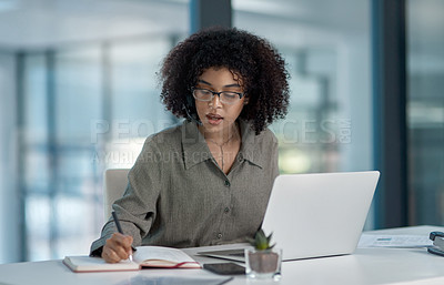 Buy stock photo Shot of a young female agent in thought while taking notes working in a call centre