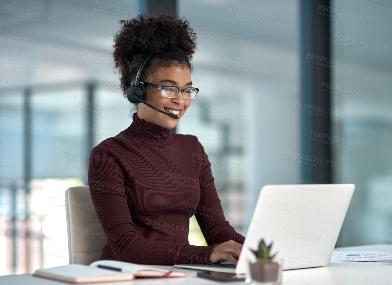 Buy stock photo Shot of a young female agent smiling while assisting on a call working in a call centre