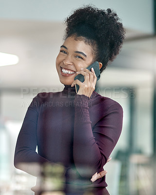 Buy stock photo Shot of a confident young woman using her mobile phone at work smiling with her arm folded
