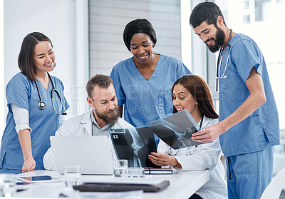 Buy stock photo Shot of a group of medical practitioners analysing x-rays in a hospital boardroom