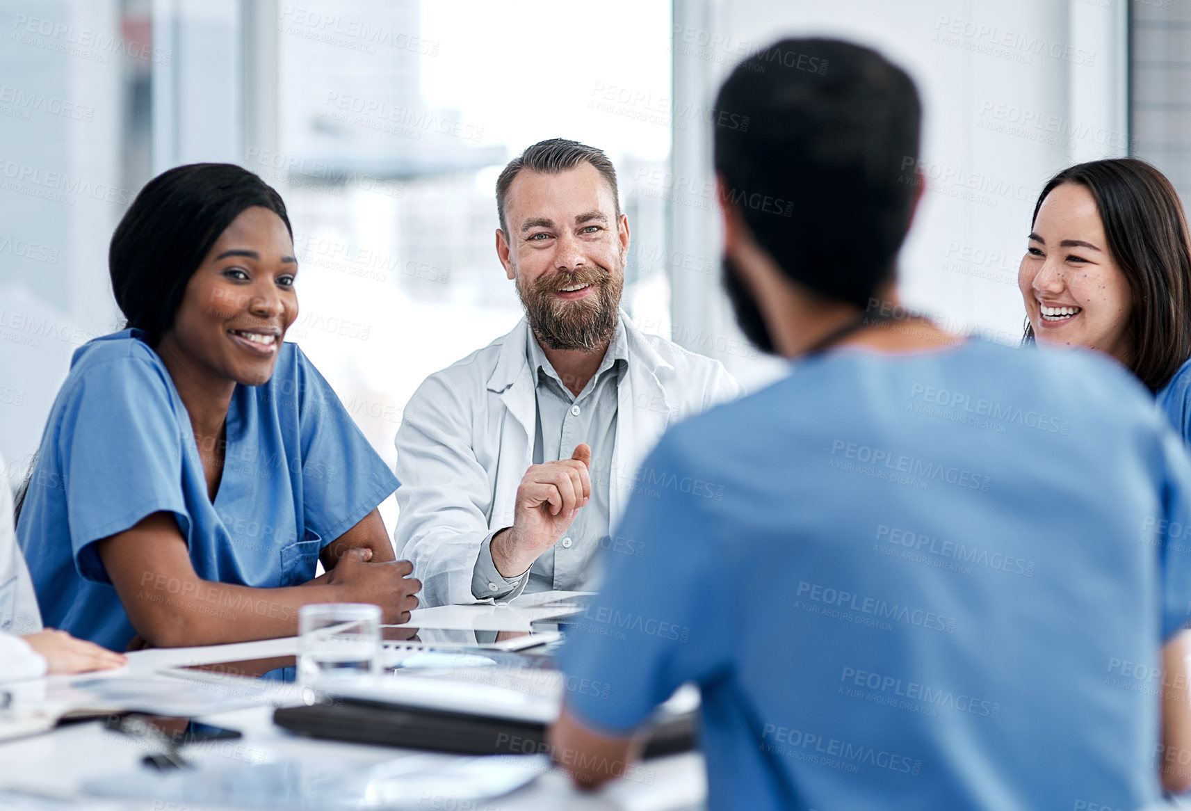 Buy stock photo Shot of a group of medical practitioners having a meeting in a hospital boardroom