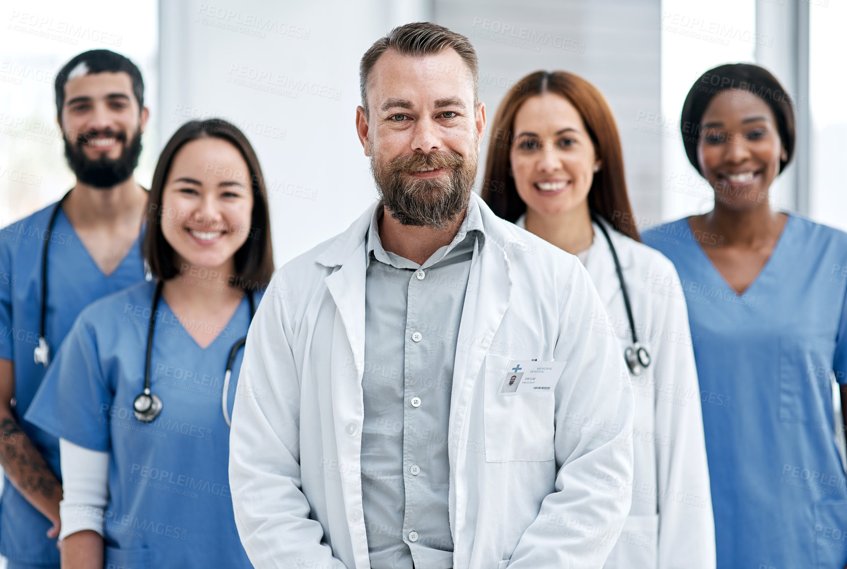 Buy stock photo Portrait of a group of medical practitioners standing together in a hospital