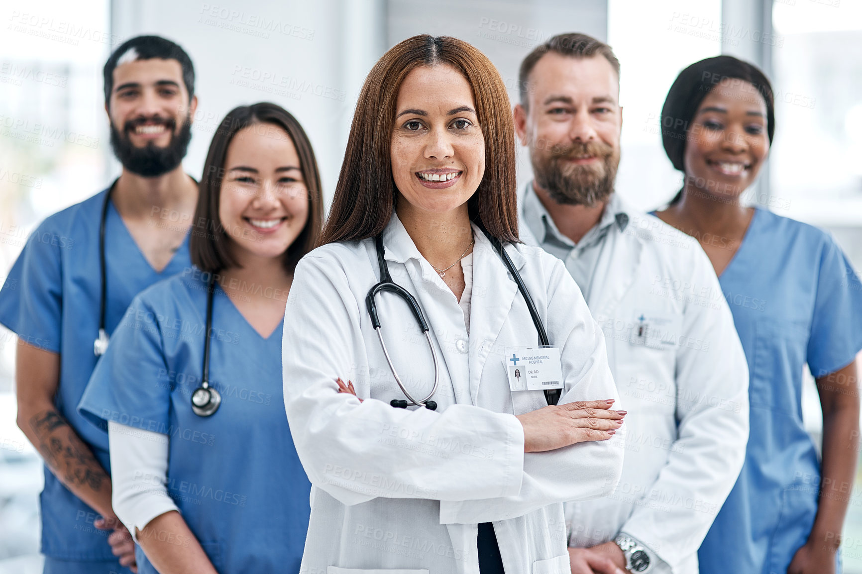 Buy stock photo Portrait of a group of medical practitioners standing together in a hospital