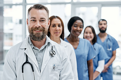 Buy stock photo Portrait of a group of medical practitioners standing together in a hospital