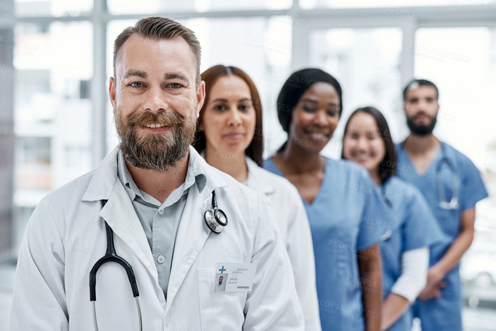 Buy stock photo Portrait of a group of medical practitioners standing together in a hospital