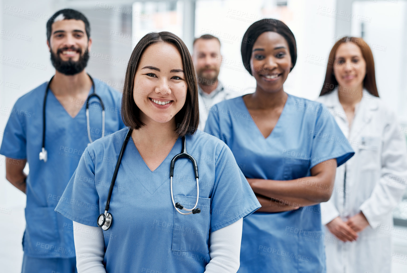 Buy stock photo Portrait of a group of medical practitioners standing together in a hospital